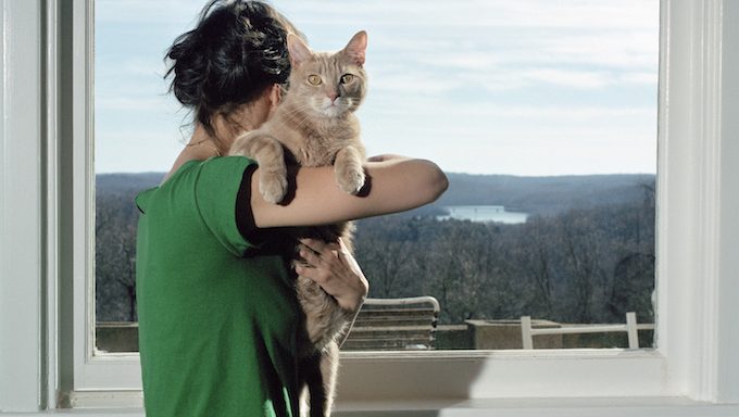 woman hugging cat