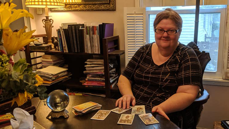 Vianne, pet psychic, sits with tarot cards