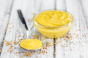 Mustard as high detailed close-up shot on a vintage wooden table (selective focus)